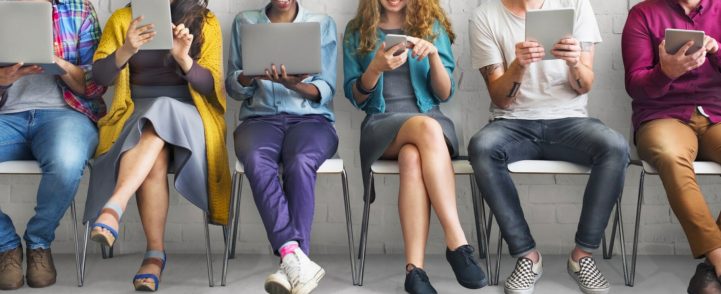 people sitting down using gadgets